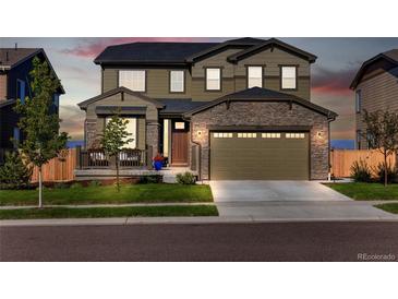 Beautiful two-story home featuring stone accents, a covered porch, and a two-car garage at 12841 Galapago St, Westminster, CO 80234
