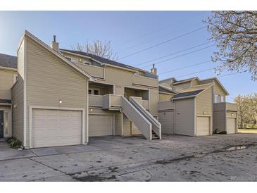 An exterior elevation shows a multi-unit residential home with beige siding and stairs to the units at 5075 Garrison St # 3, Wheat Ridge, CO 80033