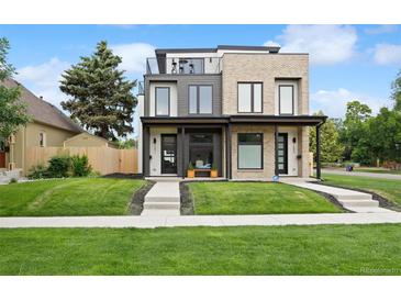 Contemporary home featuring a rooftop deck and well-manicured lawn at 2391 King St, Denver, CO 80211