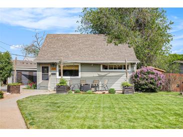 Charming single Gathering home showcasing a well-manicured lawn, mature trees and colorful flowers at 2595 S Irving St, Denver, CO 80219