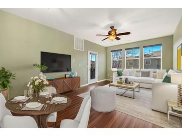 Bright and airy living room with hardwood floors, a ceiling fan, and large windows that let in plenty of natural light at 9633 E 5Th Ave # 10208, Denver, CO 80230