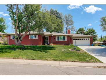 Charming brick ranch-style home with a well-manicured lawn and a two-car attached garage at 3090 S High St, Denver, CO 80210
