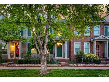 Charming two-story home with a well-maintained front yard and inviting green door at 8421 E 29Th Ave, Denver, CO 80238