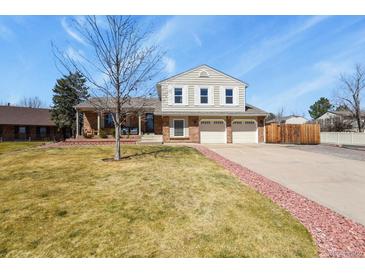Charming two-story home featuring an attached two-car garage, well-maintained lawn, and beautiful red rock landscaping at 3785 E 134Th Ct, Thornton, CO 80241