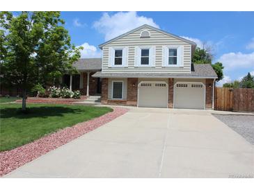 Charming two-story home featuring a two-car garage, well-maintained lawn, and mature trees in a desirable neighborhood at 3785 E 134Th Ct, Thornton, CO 80241