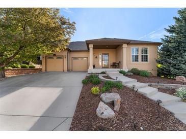Charming single-story home featuring a well-manicured front yard and attached two-car garage at 5662 W Peakview Pl, Littleton, CO 80123