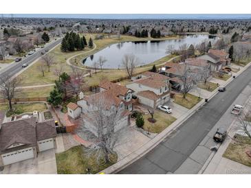 View of a home next to a peaceful lake in a quiet neighborhood at 18292 E Caspian Pl, Aurora, CO 80013