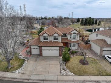 Charming two-story home with a well-manicured lawn, three-car garage, and beautiful landscaping at 18292 E Caspian Pl, Aurora, CO 80013
