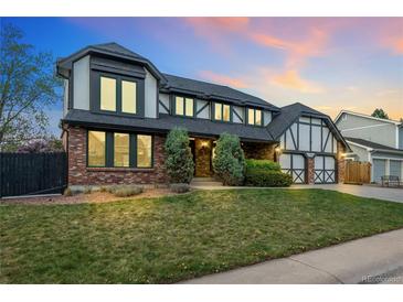 Charming two-story home with brick and Tudor accents, mature landscaping, and attached two-car garage at 7706 S Crocker Ct, Littleton, CO 80120