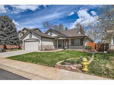 Charming single-Gathering home with manicured lawn and stone accents at 15901 W 66Th Pl, Arvada, CO 80007