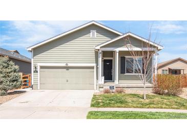 Charming single-story home featuring a two-car garage and a well-maintained front yard at 481 Vista Blvd, Brighton, CO 80603