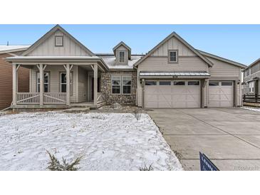 Charming home featuring stone accents, a covered porch, and a convenient two-car garage at 3929 Treadway Pt, Castle Rock, CO 80108
