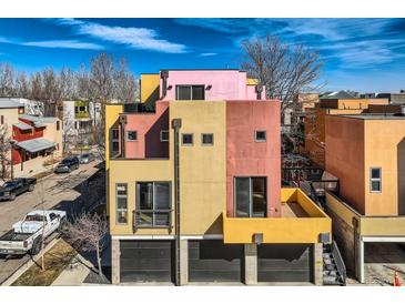 Modern, multi-story home showcasing a unique color block design and a sleek, contemporary aesthetic at 801 Confidence Dr # 9, Longmont, CO 80504