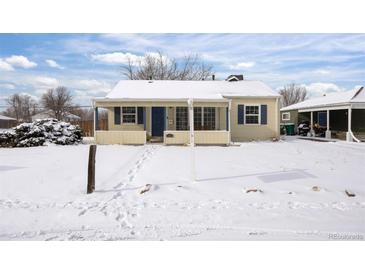 Cute bungalow with snow covered yard at 1901 Clinton St, Aurora, CO 80010