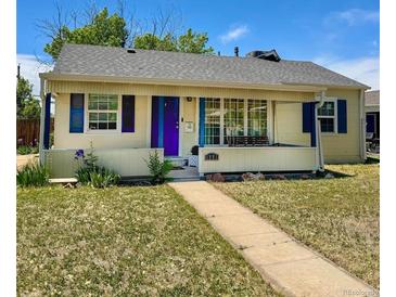 Charming single-story home features a cozy front porch swing, bright blue shutters and door, and a well-maintained lawn at 1901 Clinton St, Aurora, CO 80010