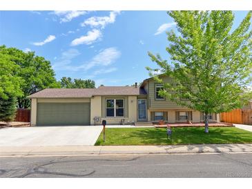 Charming split-level home featuring a well-maintained front yard and attached two-car garage at 10926 Dahlia Way, Thornton, CO 80233