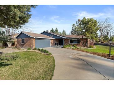 Charming single-story brick home with an attached garage and well-manicured front yard at 10801 W 29Th Ave, Lakewood, CO 80215