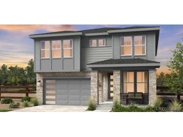 Two-story house with gray siding, stone accents, and a two-car garage at 7255 Prairie Sage Pl, Littleton, CO 80125