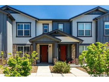 Charming townhome with a covered entry and well-maintained landscaping at 157 Ambrose St, Erie, CO 80516