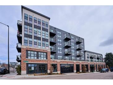 Modern apartment building featuring a brick and gray facade, multiple balconies, and street-level retail at 3500 S Corona St # 409, Englewood, CO 80113
