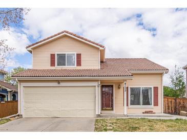 Charming two-story home with a well-manicured front yard and attached two-car garage at 4152 Netherland St, Denver, CO 80249