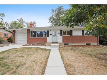 Charming single-story home with brick accents, a well-manicured lawn, and attached garage at 2251 Braun Dr, Golden, CO 80401