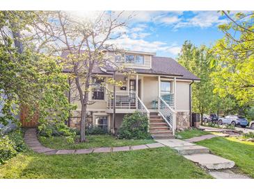 Charming home featuring stone accents, a well-manicured lawn, and a inviting front porch with elegant railings at 2507 9Th St, Boulder, CO 80304
