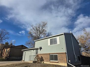 Charming two-story home featuring a brick foundation and vinyl siding at 4247 S Pitkin St, Aurora, CO 80013