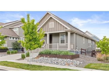 Charming home with a covered porch and rock garden at 757 Cabot Dr, Erie, CO 80516