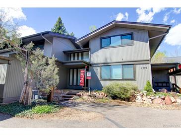 Contemporary gray home with well-maintained landscaping and prominent for sale sign out front at 1172 Juniper Ave, Boulder, CO 80304