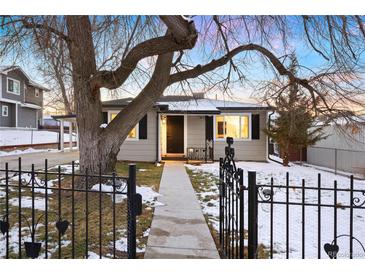 Charming ranch home with a landscaped front yard and walkway at 5231 Quitman St, Denver, CO 80212