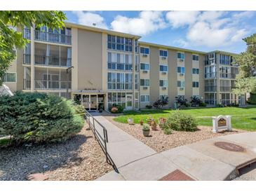Attractive condo building with a manicured lawn and professional landscaping at 13626 E Bates Ave # 207, Aurora, CO 80014