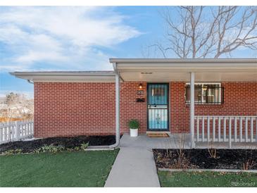 Charming brick home featuring a cozy covered porch and walkway leading to the front door at 1476 W Dakota Ave, Denver, CO 80223