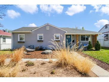 Charming single-story home with a well-maintained front yard and beautiful landscaping at 4374 S Washington St, Englewood, CO 80113
