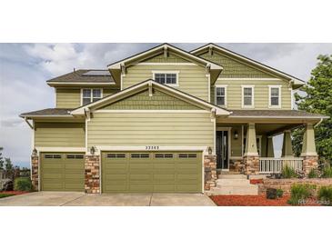 Charming two-story home featuring a well-manicured lawn and an attached two-car garage at 23503 E Minnow Dr, Aurora, CO 80016