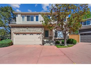 Charming two-story home with a brick facade, two-car garage, and a well-maintained front yard at 1272 Braewood Ave, Highlands Ranch, CO 80129