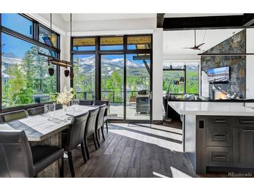 Bright dining room with mountain views and large table at 52 West Point Lode # A, Breckenridge, CO 80424