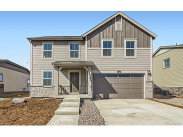 Charming two-story home featuring mixed siding, a two-car garage, and a welcoming front porch at 3919 N Shawnee St, Aurora, CO 80019