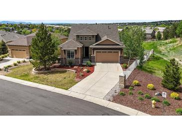 Beautiful two-story home featuring manicured landscaping and a spacious driveway at 7367 S Tempe Ct, Aurora, CO 80016
