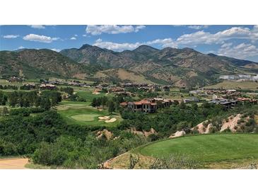 Picturesque golf course community nestled against a stunning mountain backdrop with lush green fairways and luxurious homes at 11160 Dolce Vita Pl, Littleton, CO 80125