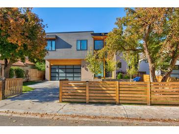 Modern two-story home with wood fence and attached garage at 3485 S Clermont St, Denver, CO 80222