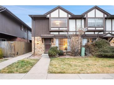 Exterior view of a two-story townhome with a small front yard and walkway at 3855 S Monaco St # 176, Denver, CO 80237