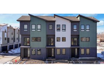 Modern three-story townhomes with gray and green exterior at 8404 W 52Nd St, Arvada, CO 80002