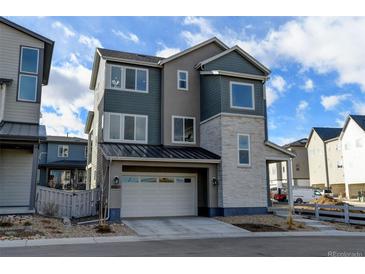 Two-story modern home with attached garage and light-grey siding at 11728 Octave Ave, Lone Tree, CO 80134