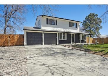 Two story home featuring a three car garage, lovely landscaping and fresh exterior paint at 6087 W 84Th Ave, Arvada, CO 80003