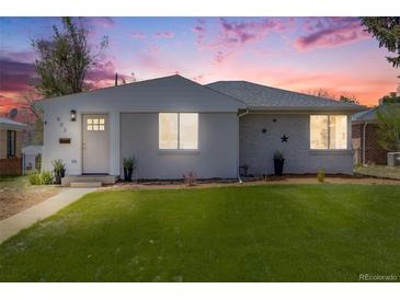 Charming single-story home with a well-manicured lawn and inviting front entrance at dusk at 903 Poplar St, Denver, CO 80220