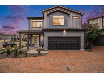 Charming two-story home with a paved driveway and well-manicured landscaping at 17996 E 54Th Ave, Denver, CO 80249