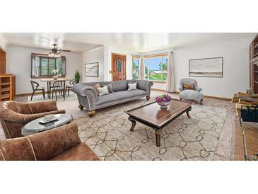 Spacious living room with large windows, hardwood floors, and comfortable seating at 3790 W 54Th Ave, Denver, CO 80221
