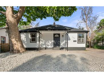 Charming single-story home with white siding, a covered porch, and gravel landscaping at 1636 Geneva St, Aurora, CO 80010