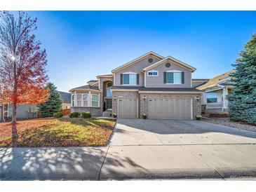 Two-story house with a three-car garage and landscaped yard at 678 Kryptonite Dr, Castle Rock, CO 80108